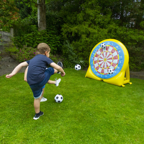 Kickball Football child playing with the football dartboard game in the garden